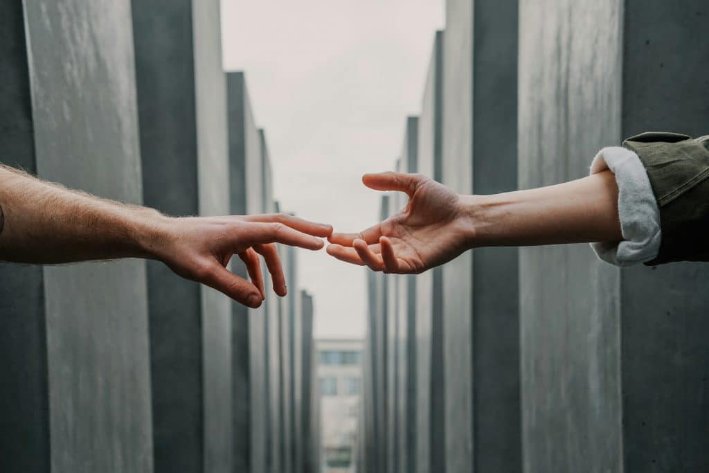 Two hands reaching as to symbolise help